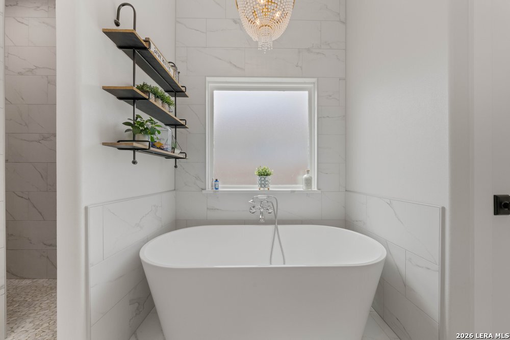 116 Park Heights Poth, TX 78147 - Photo 28 of 48 a white bath tub sitting next to a window