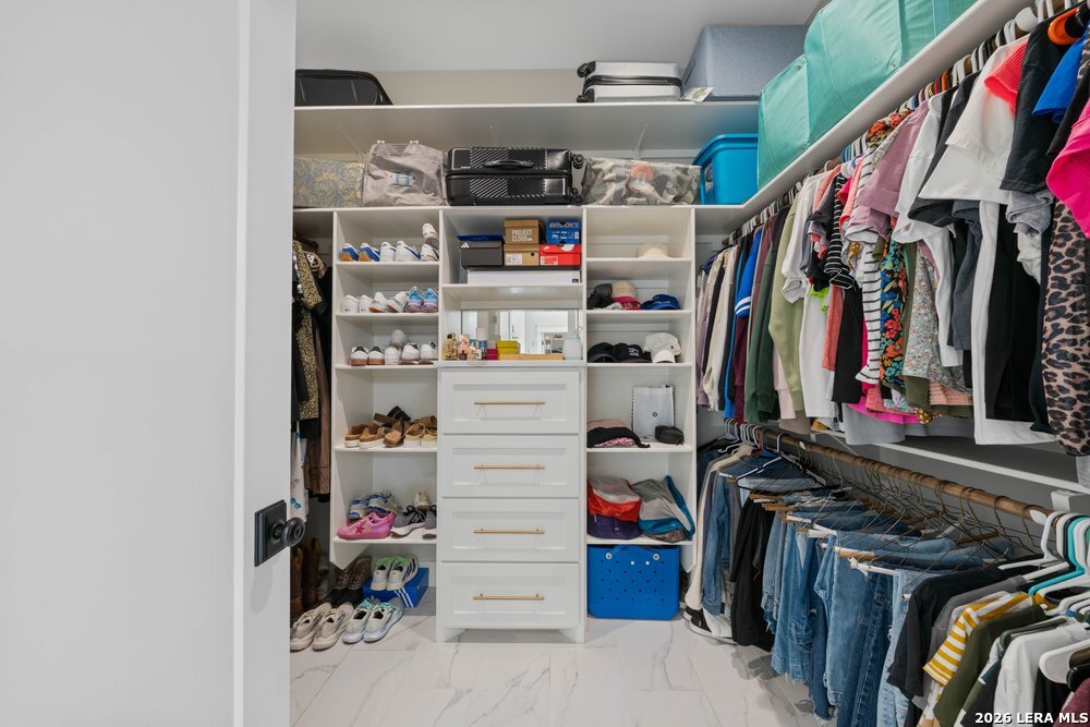 116 Park Heights Poth, TX 78147 - Photo 31 of 48 a view of walk in closet with clothes and shoes