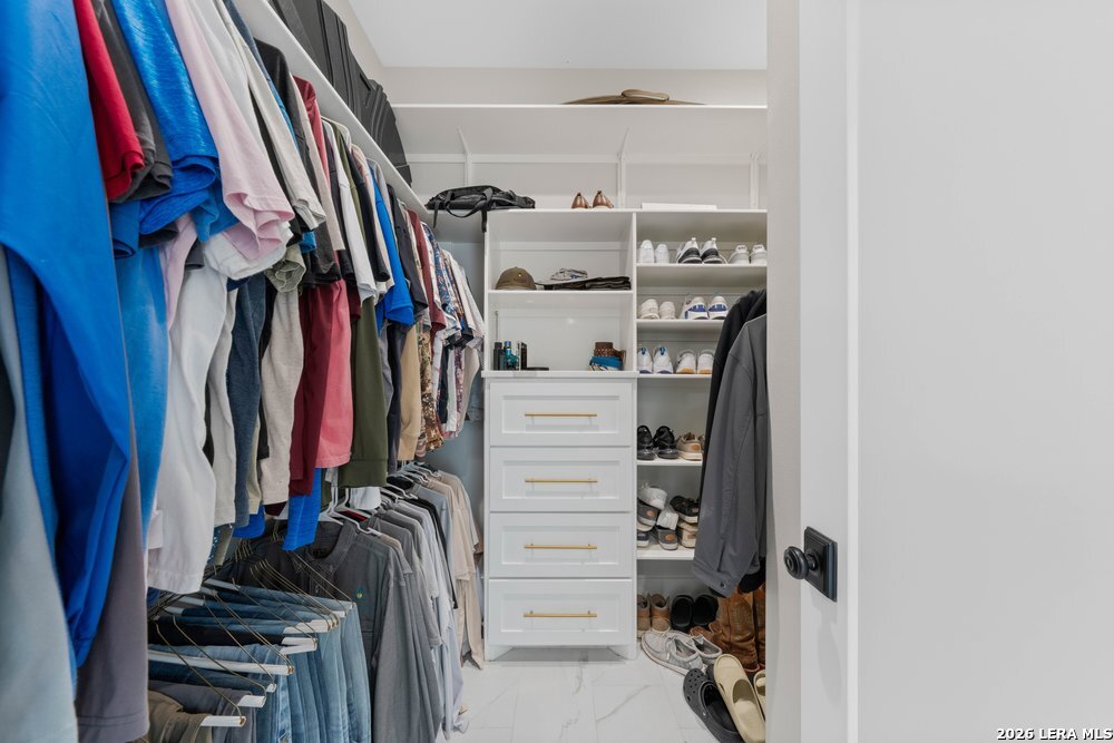 116 Park Heights Poth, TX 78147 - Photo 32 of 48 a view of walk in closet with clothes and shoes