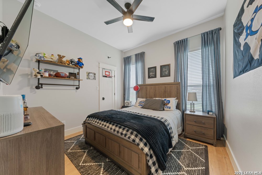 116 Park Heights Poth, TX 78147 - Photo 33 of 48 a bedroom with a bed and a chandelier