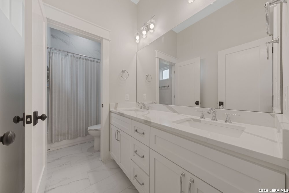116 Park Heights Poth, TX 78147 - Photo 35 of 48 a spacious bathroom with a granite countertop sink mirror and double