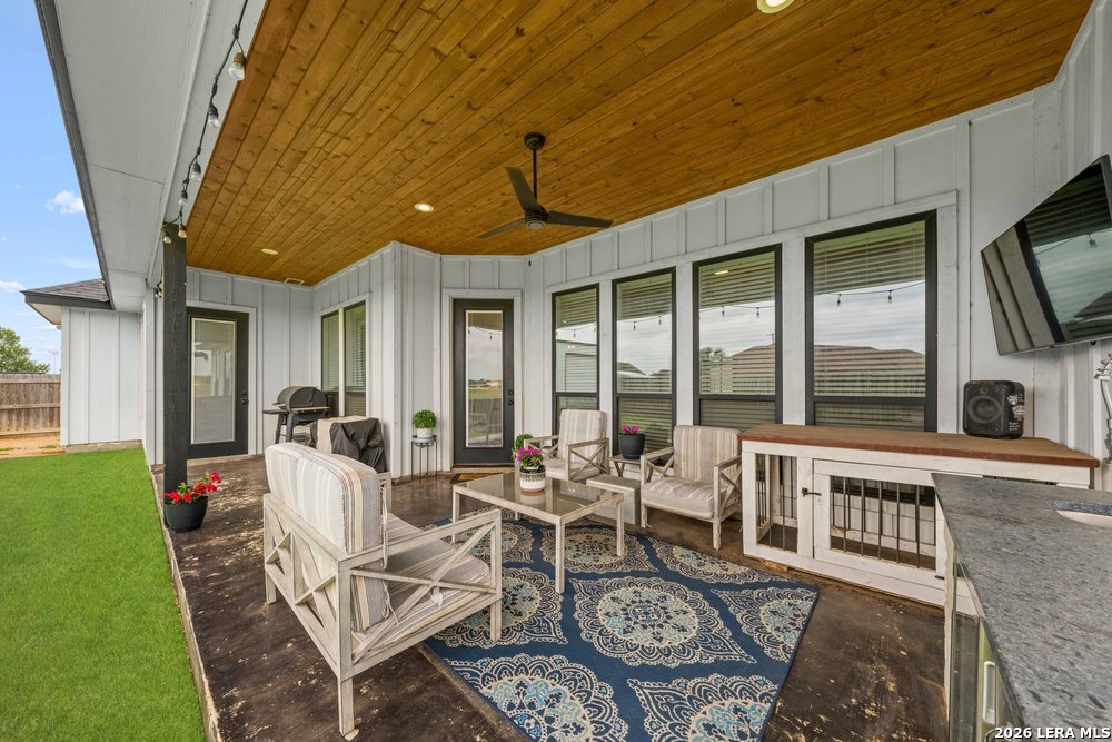 116 Park Heights Poth, TX 78147 - Photo 41 of 48 a living room with furniture a flat screen tv and a floor to ceiling window