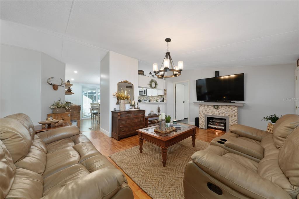 708 Fazzini Road Babson Park, FL 33827 - Photo 13 of 47 a living room with furniture a flat screen tv and a fireplace