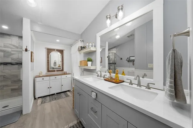 a bathroom with a shower a toilet and a sink