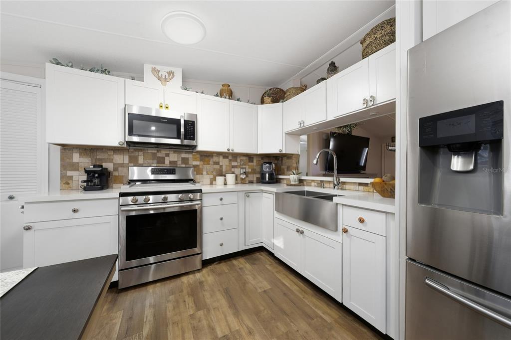 708 Fazzini Road Babson Park, FL 33827 - Photo 8 of 47 a kitchen with stainless steel appliances a stove a sink and a microwave