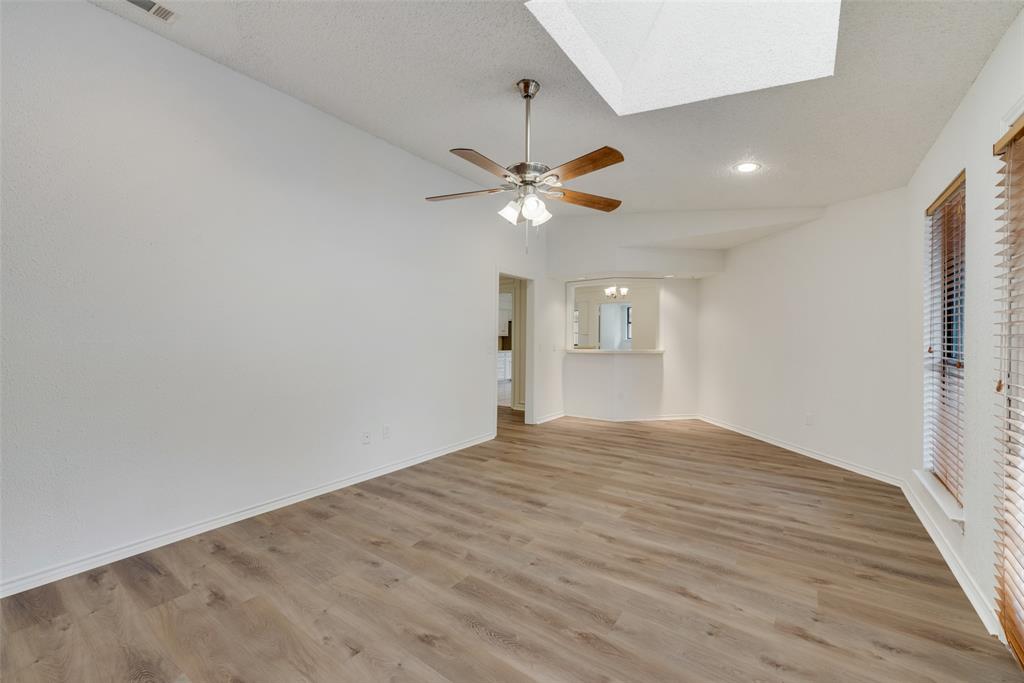 208 Timber Ridge Drive Murphy, TX 75094 - Photo 13 of 22 wooden floor in an empty room with a window