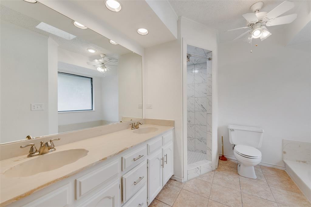 208 Timber Ridge Drive Murphy, TX 75094 - Photo 19 of 22 a spacious bathroom with a granite countertop sink a toilet and a mirror