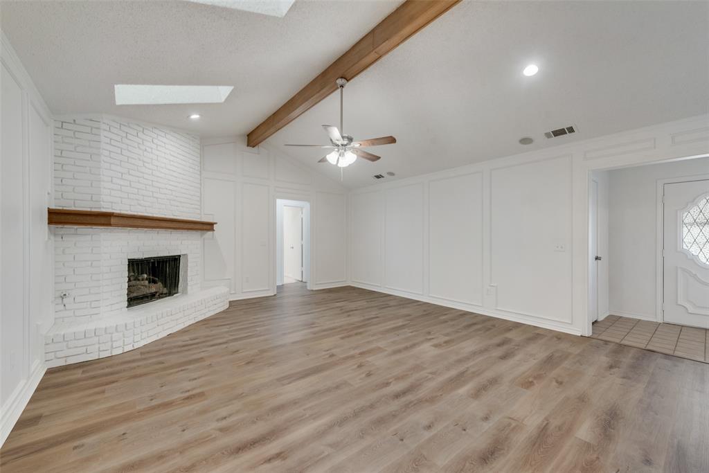 208 Timber Ridge Drive Murphy, TX 75094 - Photo 4 of 22 a view of an empty room with a fireplace and a window