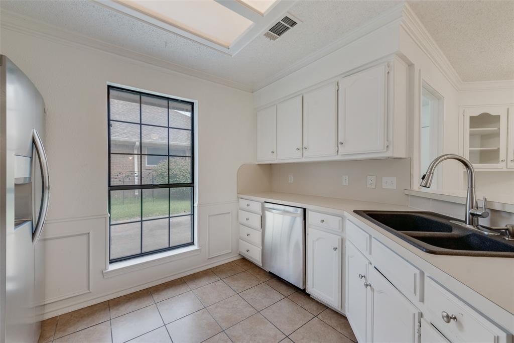 208 Timber Ridge Drive Murphy, TX 75094 - Photo 6 of 22 a kitchen with a sink and cabinets