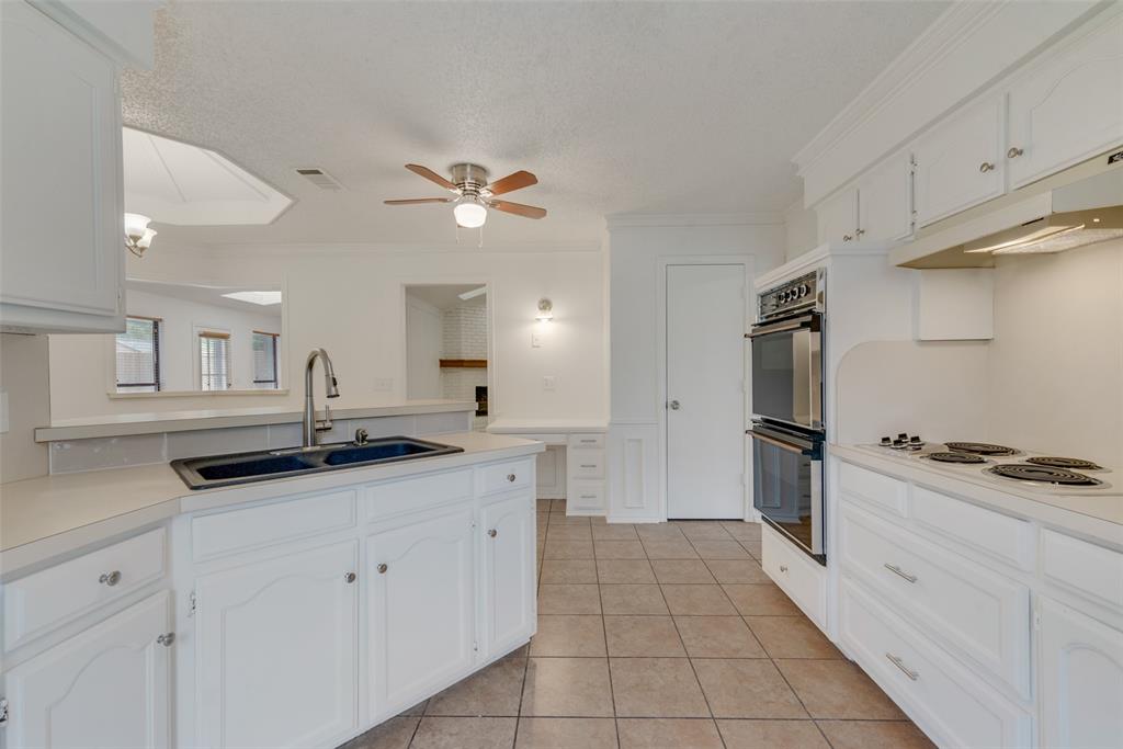 208 Timber Ridge Drive Murphy, TX 75094 - Photo 7 of 22 a kitchen with granite countertop a stove a sink and a refrigerator