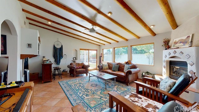 a living room with furniture a fireplace and a large window