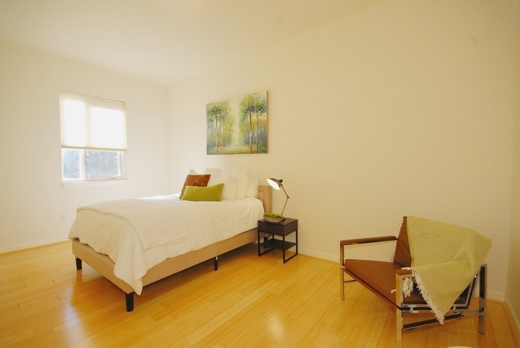 100 Keyes Road, Unit 307 Concord, MA 01742 - Photo 16 of 32 a bedroom with a bed and chair