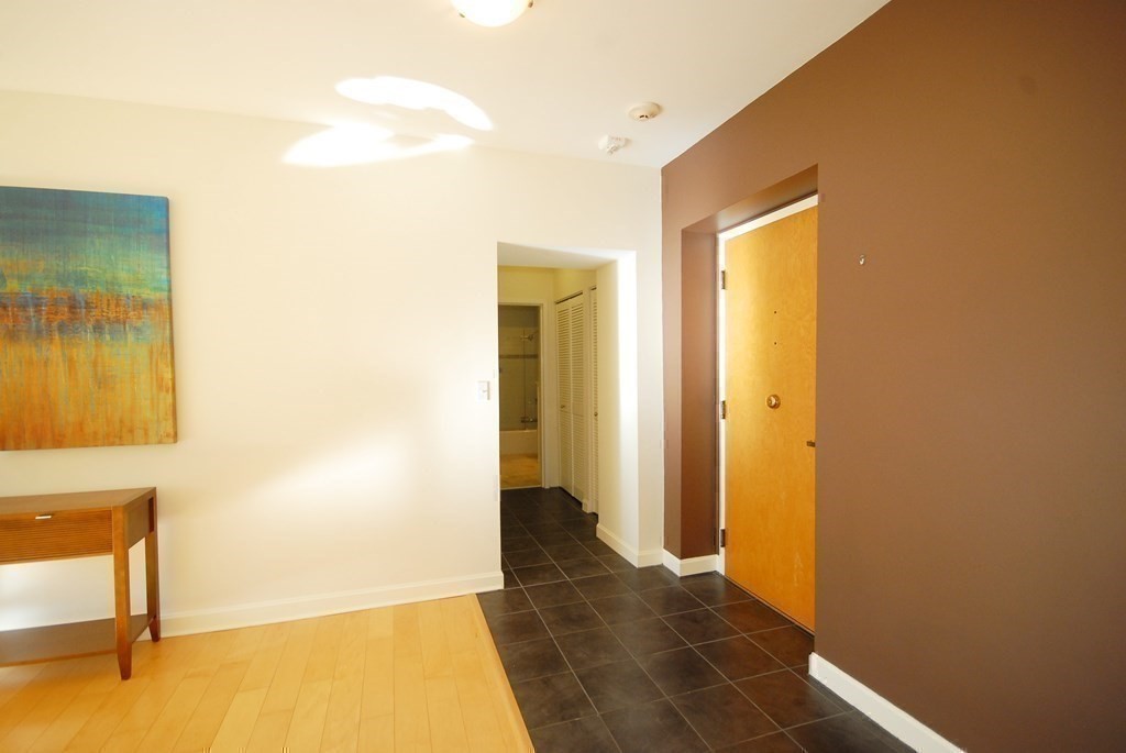 100 Keyes Road, Unit 307 Concord, MA 01742 - Photo 20 of 32 a view of a livingroom with wooden floor and a bathroom