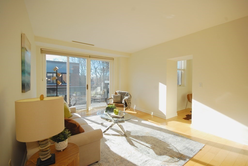 100 Keyes Road, Unit 307 Concord, MA 01742 - Photo 2 of 32 a living room with furniture and a large window