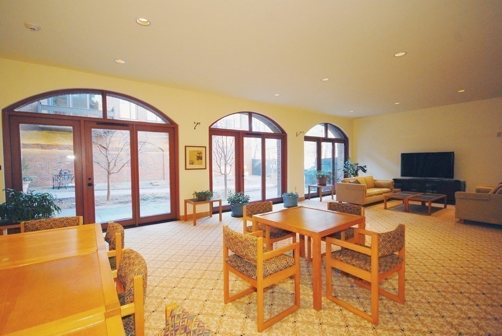 100 Keyes Road, Unit 307 Concord, MA 01742 - Photo 26 of 32 a dining room with furniture and a large window