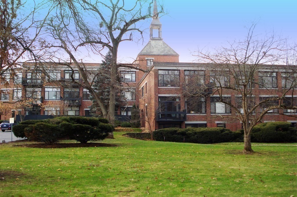 100 Keyes Road, Unit 307 Concord, MA 01742 - Photo 30 of 32 a front view of a house with a garden and trees