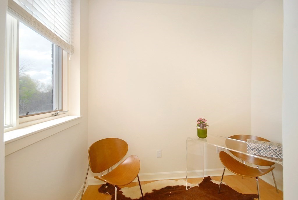 100 Keyes Road, Unit 307 Concord, MA 01742 - Photo 4 of 32 a view of workspace room with wooden floor and chair