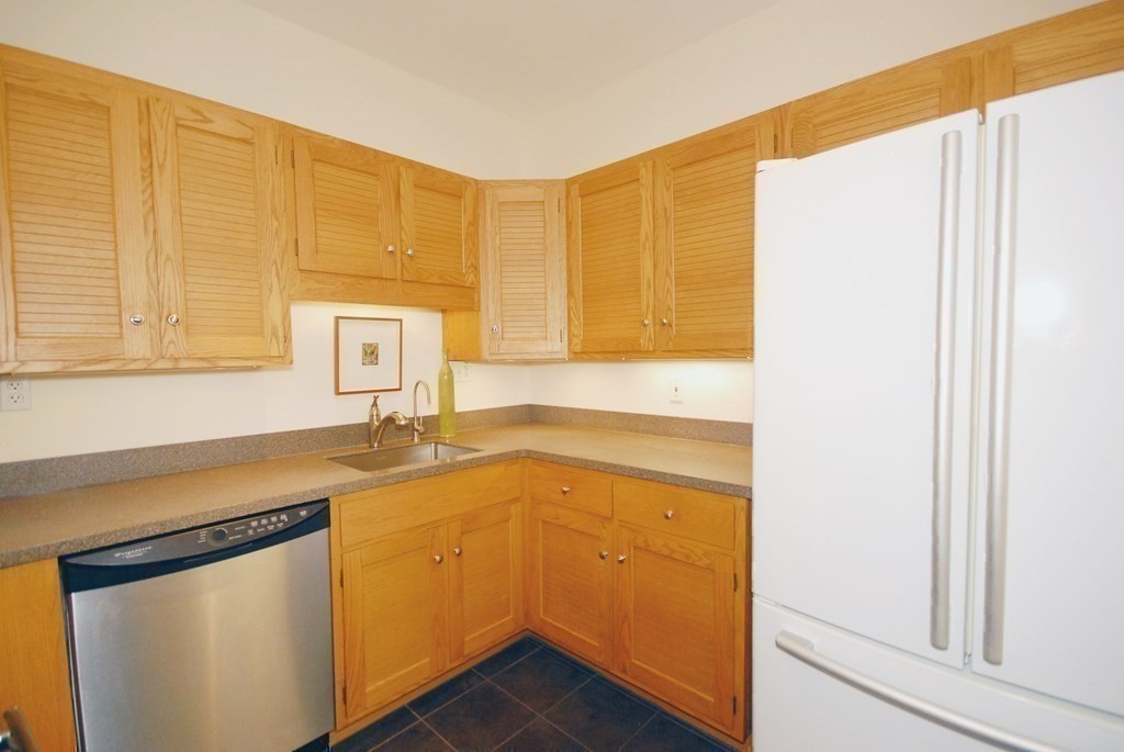 100 Keyes Road, Unit 307 Concord, MA 01742 - Photo 9 of 32 a bathroom with a granite countertop sink and a mirror