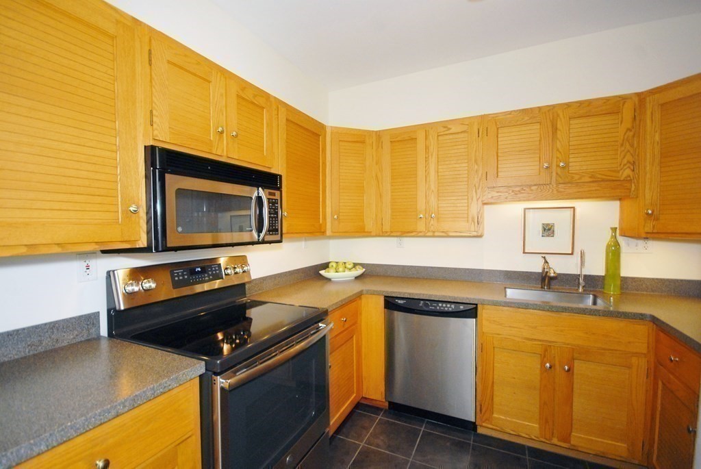 100 Keyes Road, Unit 307 Concord, MA 01742 - Photo 10 of 32 a kitchen with a sink stove and microwave