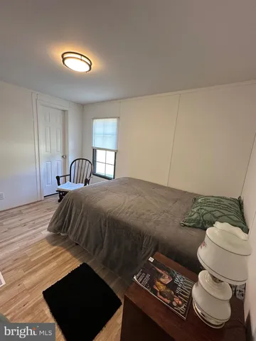 a bedroom with a bed and a lamp