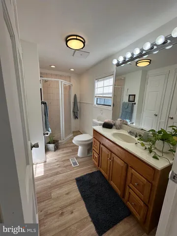 a bathroom with a double vanity sink mirror and toilet
