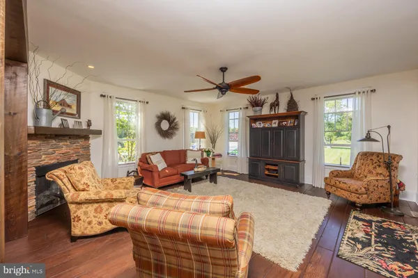 a living room with furniture stove and a fireplace