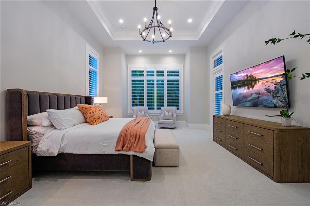 6830 Mangrove Avenue Naples, FL 34109 - Photo 16 of 28 a spacious bedroom with a bed and a flat screen tv