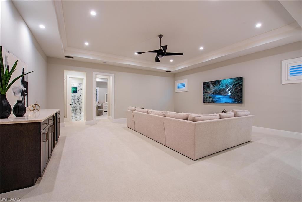 6830 Mangrove Avenue Naples, FL 34109 - Photo 19 of 28 a living room with furniture and a flat screen tv