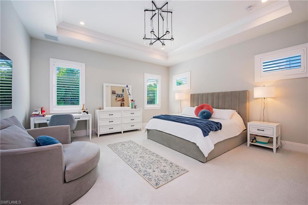 6830 Mangrove Avenue Naples, FL 34109 - Photo 21 of 28 a bed room with a bed and a couch