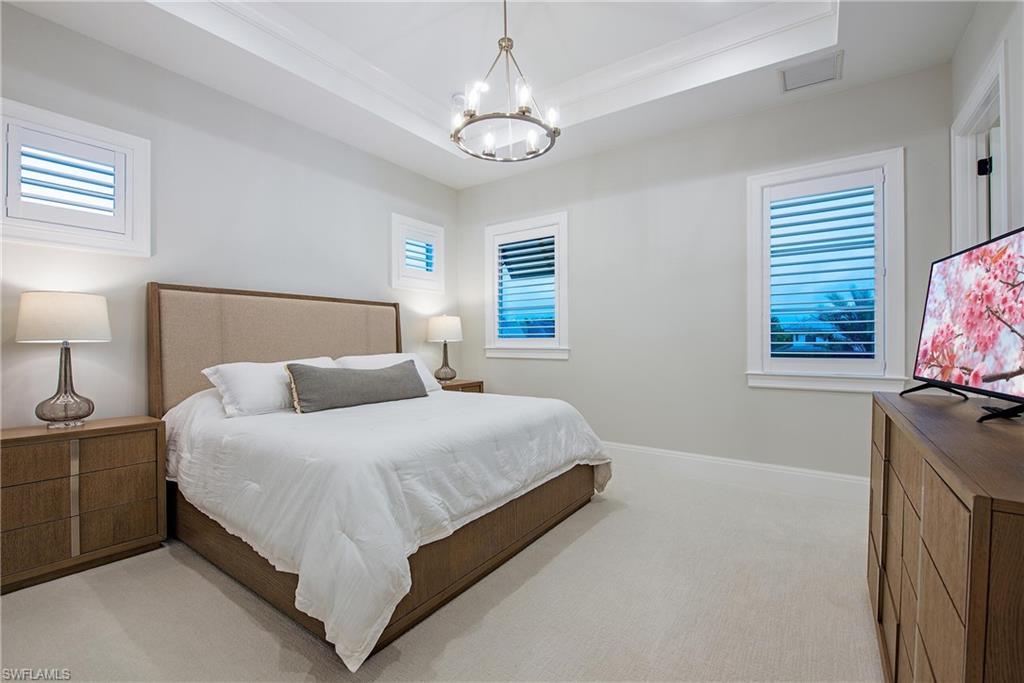 6830 Mangrove Avenue Naples, FL 34109 - Photo 23 of 28 a bedroom with bed and window