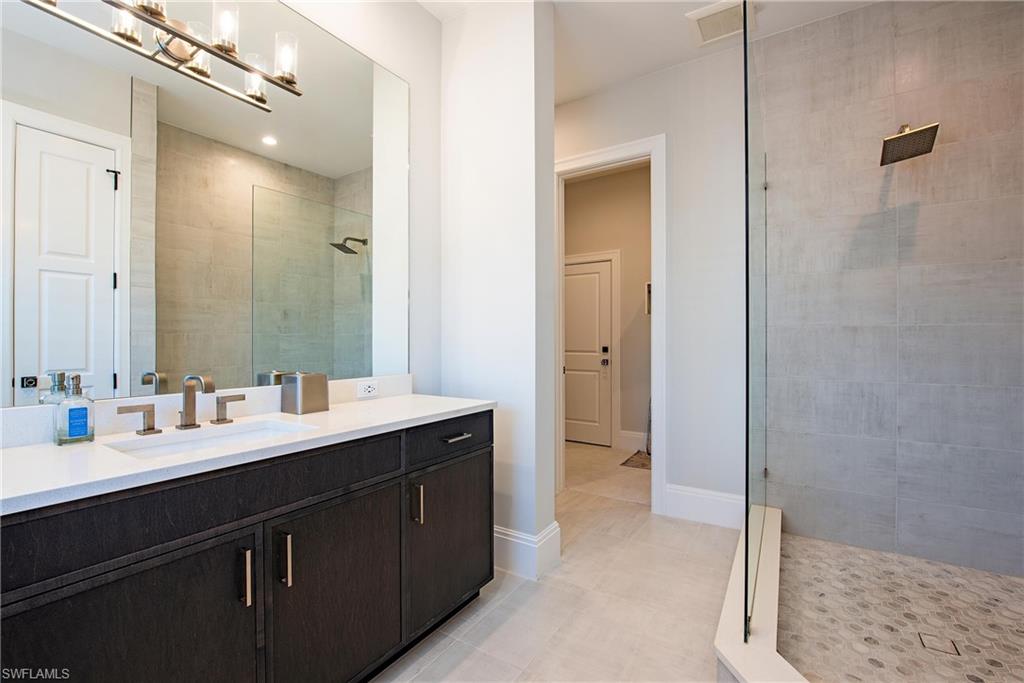 6830 Mangrove Avenue Naples, FL 34109 - Photo 24 of 28 a bathroom with a double vanity sink mirror and double