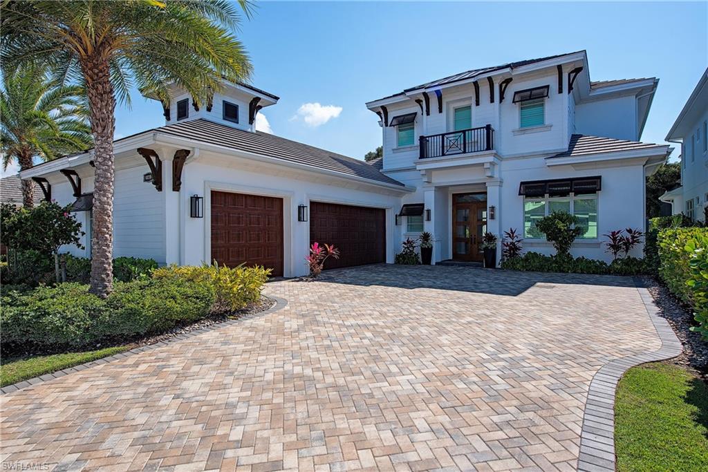 6830 Mangrove Avenue Naples, FL 34109 - Photo 27 of 28 a front view of a house with yard and trees