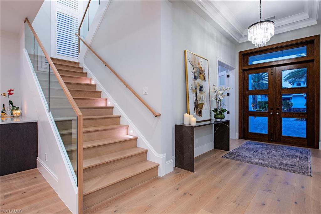6830 Mangrove Avenue Naples, FL 34109 - Photo 3 of 28 a view of entryway and hall with wooden floor
