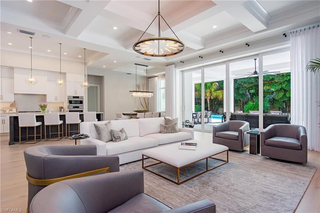 6830 Mangrove Avenue Naples, FL 34109 - Photo 4 of 28 a living room with furniture ceiling fan and a large window