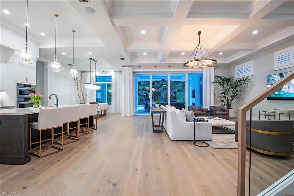 6830 Mangrove Avenue Naples, FL 34109 - Photo 6 of 28 a living room with furniture and a wooden floor