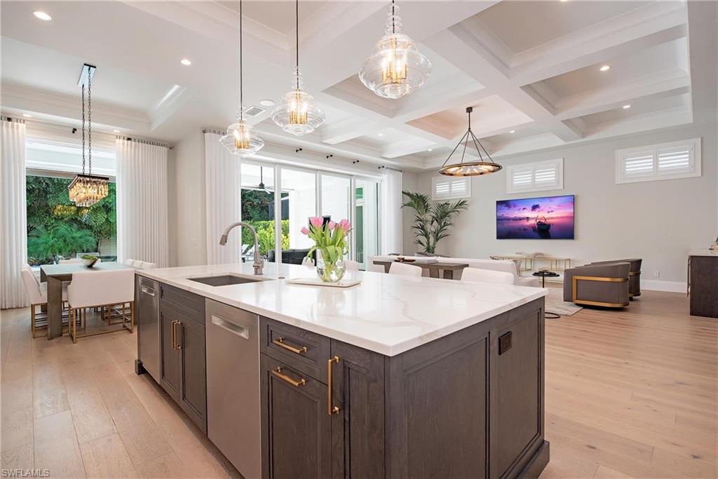 6830 Mangrove Avenue Naples, FL 34109 - Photo 8 of 28 a kitchen with a counter space a sink appliances and living room view