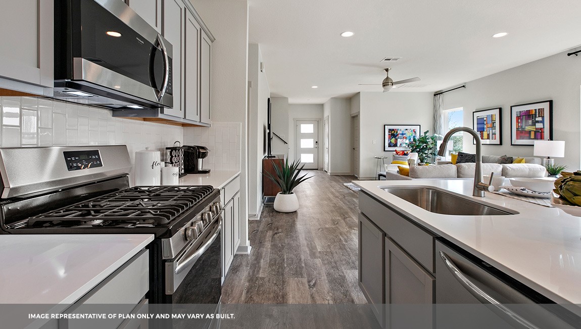 220 Century Plant Road Leander, TX 78641 - Photo 3 of 16 a kitchen with stainless steel appliances a sink a stove and cabinets