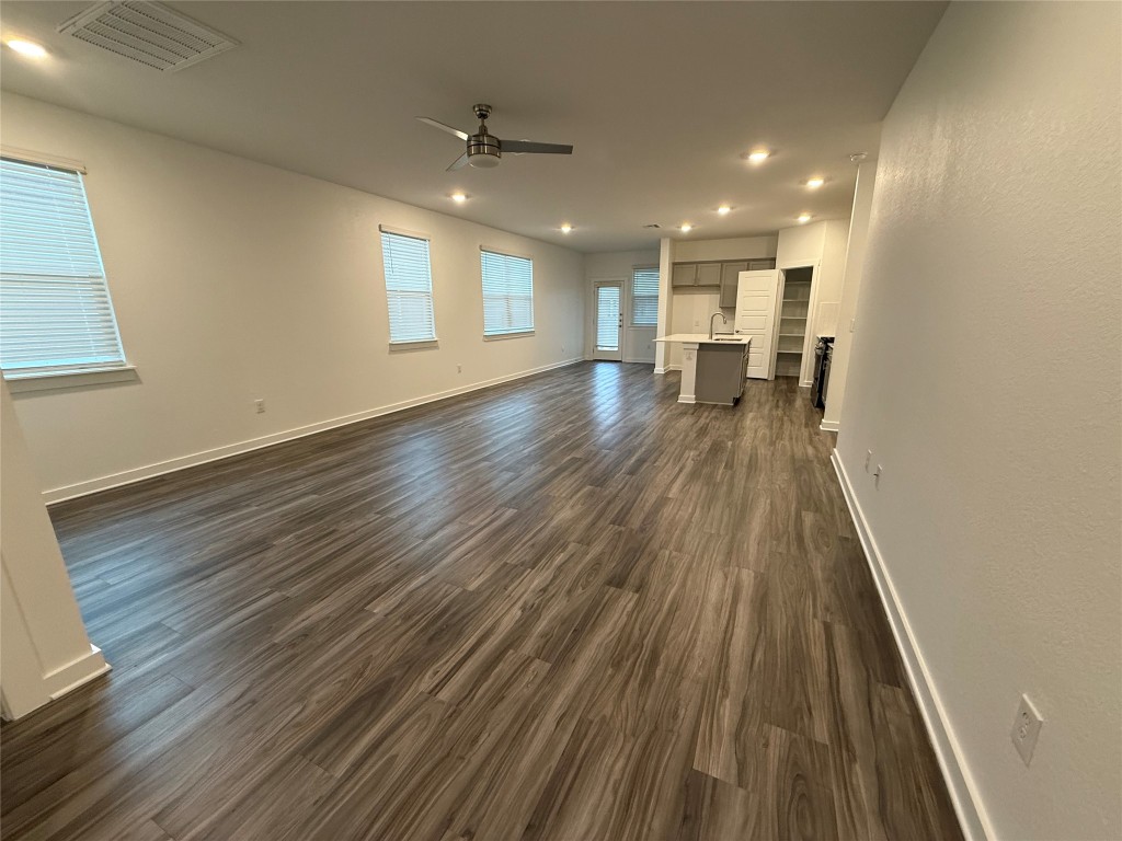 220 Century Plant Road Leander, TX 78641 - Photo 5 of 16 a view of a big room with wooden floor and windows