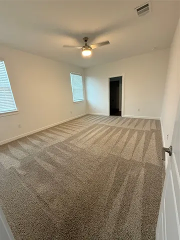 a view of an empty room and a window