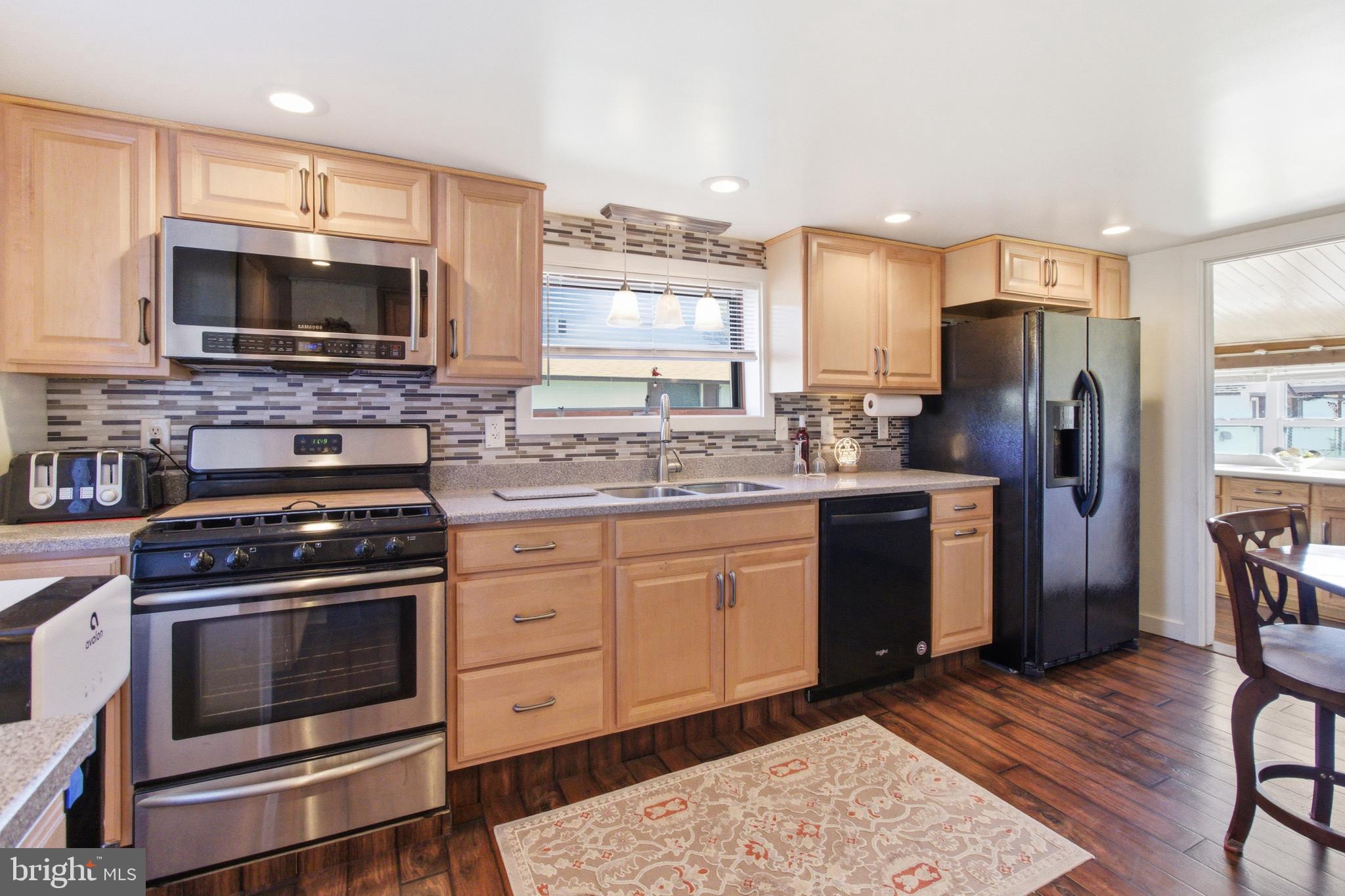 82 Ridge Street Smokerun, PA 16681 - Photo 34 of 52 a kitchen with stainless steel appliances granite countertop a stove a sink dishwasher a refrigerator and a microwave