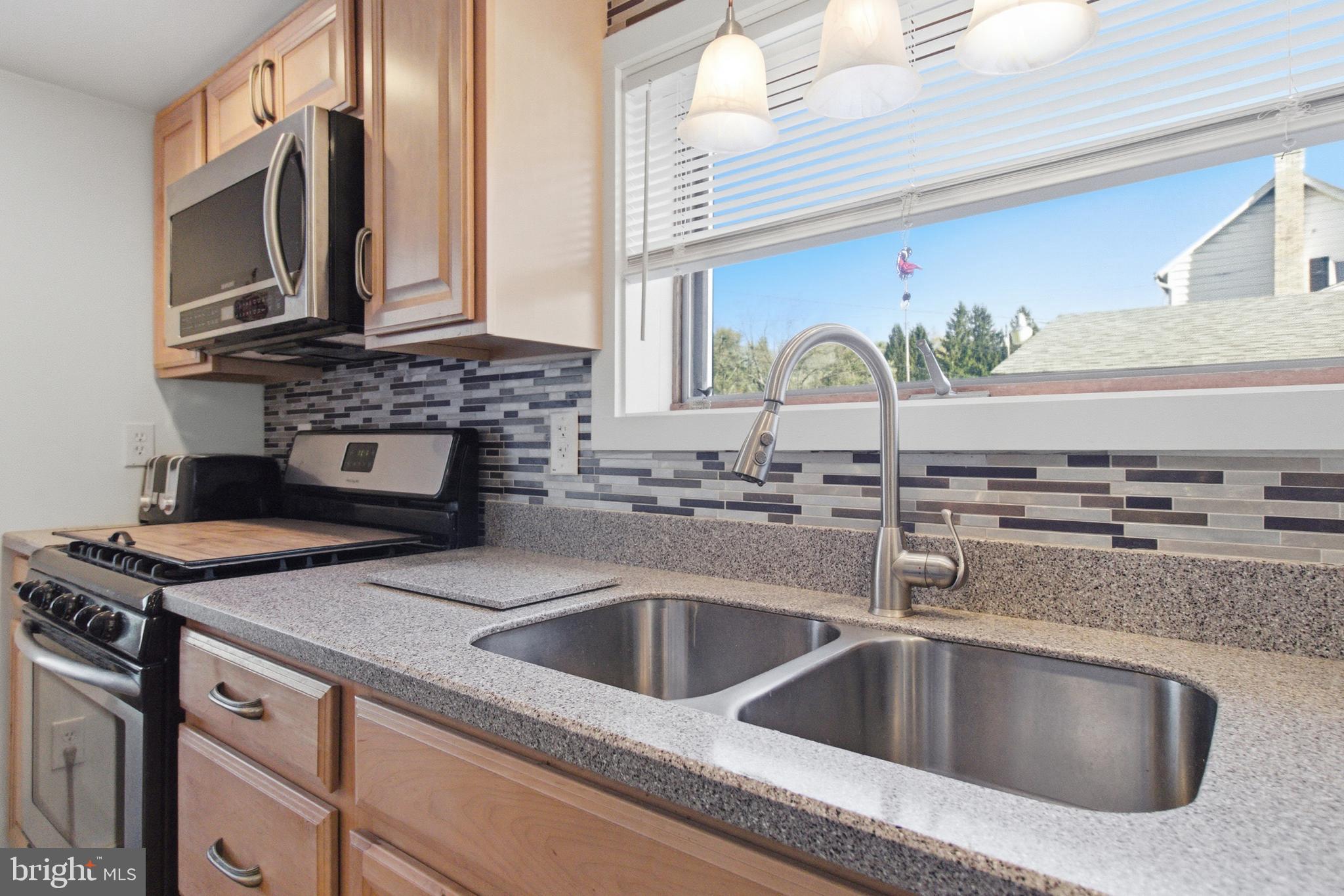 82 Ridge Street Smokerun, PA 16681 - Photo 37 of 52 a kitchen with stainless steel appliances granite countertop a sink and a stove