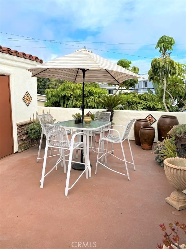 248 West Avenida Palizada, Unit 2 San Clemente, CA 92672 - Photo 20 of 21 a view of a patio with table and chairs potted plants