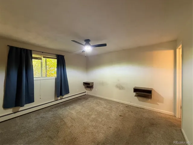an empty room with windows and closet