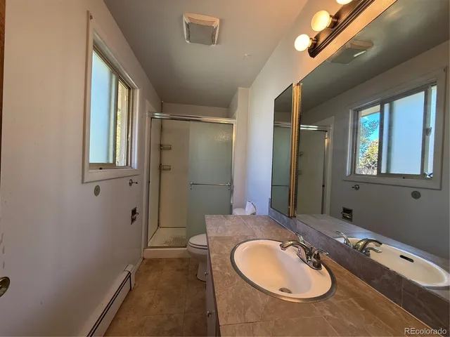 a bathroom with a sink double vanity granite and a mirror
