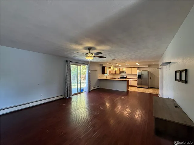 a view of kitchen and hall with wooden floor