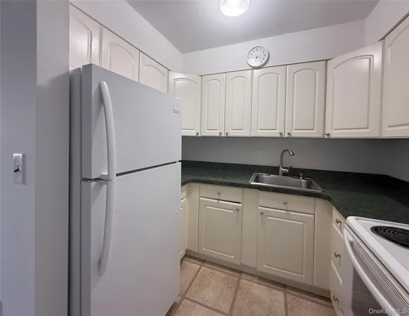 an empty room with a window and a ceiling fan