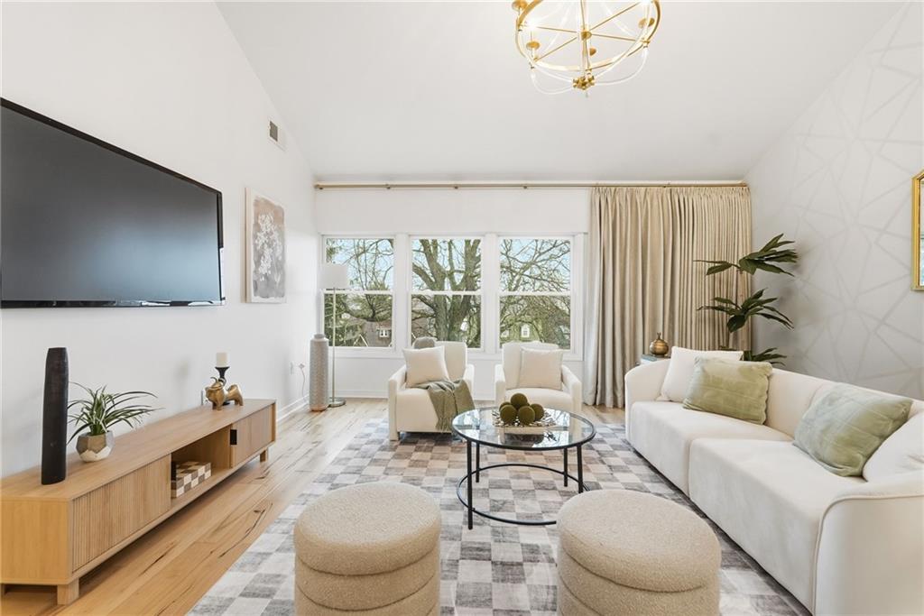 5742 Fifth Avenue, Unit 304 Pittsburgh, PA 15232 - Photo 11 of 32 a living room with furniture and a flat screen tv