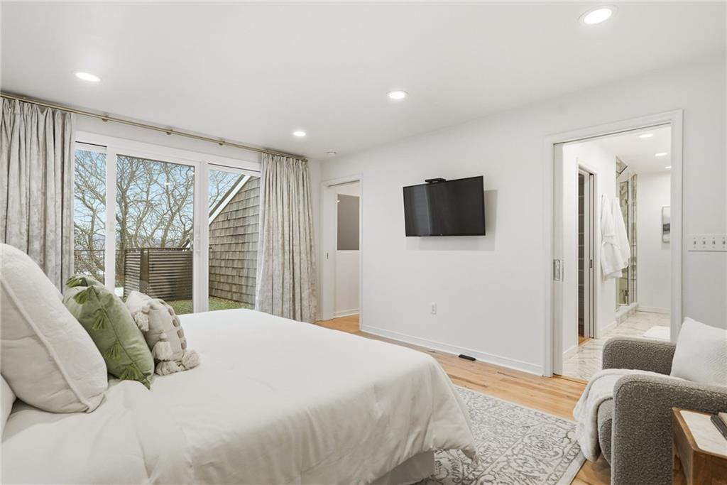 5742 Fifth Avenue, Unit 304 Pittsburgh, PA 15232 - Photo 17 of 32 a bedroom with a bed and a flat screen tv