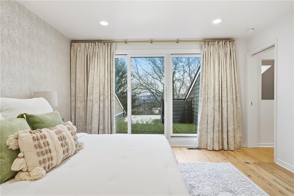 5742 Fifth Avenue, Unit 304 Pittsburgh, PA 15232 - Photo 18 of 32 a bedroom with a large bed and a large window