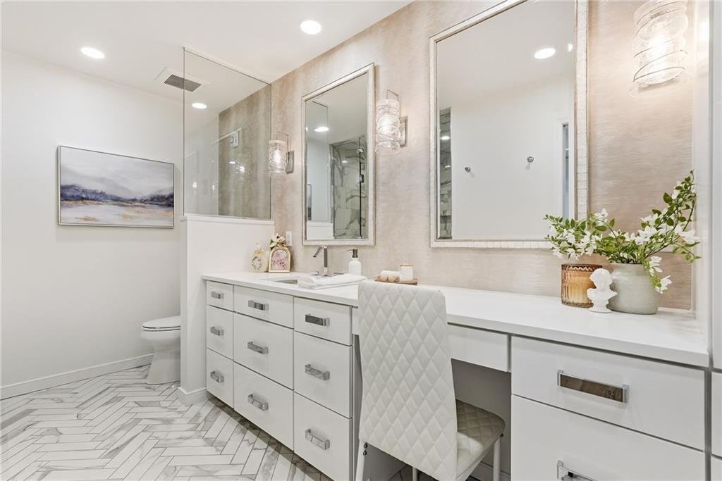 5742 Fifth Avenue, Unit 304 Pittsburgh, PA 15232 - Photo 20 of 32 a bathroom with a sink vanity granite and a mirror